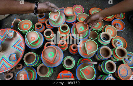 Lahore, Pakistan. 30th Oct, 2016. Pakistani Hindus family to take a part of religious rituals celebrate Diwali, the Festival of Lights and light candles as they mark Diwali. Diwali, the Festival of Lights, marks victory over evil and commemorates the time when Hindu god Lord Rama achieved victory over Ravana and returned to his kingdom Ayodhya, after vanquishing the demon king Ravana and symbolizes taking people from darkness to light and the victory of good over evil. Credit:  Rana Sajid Hussain/Pacific Press/Alamy Live News Stock Photo