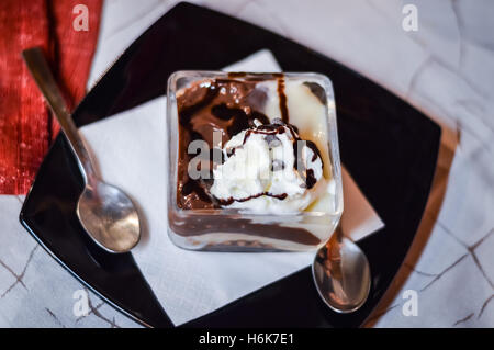 Tiramisu dessert in a square cup with two spoons Stock Photo