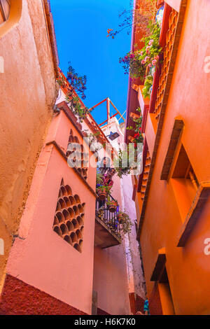 Kiss Alley Alleyway People Colored Houses Guanajuato Mexico.  Houses so close couple can exchange a kiss between balconies Stock Photo