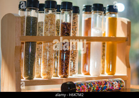 spices and sugar sprinkles in test tubes with lit background Stock Photo