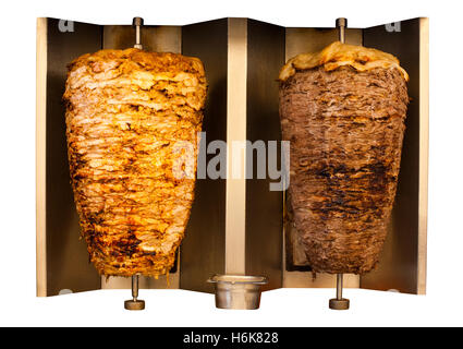 Skewered fast food chicken and lamb mutton kebab, shawarma meat cooking and turning side by side on rotating spit Arab countries Stock Photo