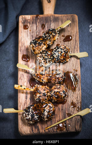 bbq chicken mini kebabs skewers with hot sauce Stock Photo