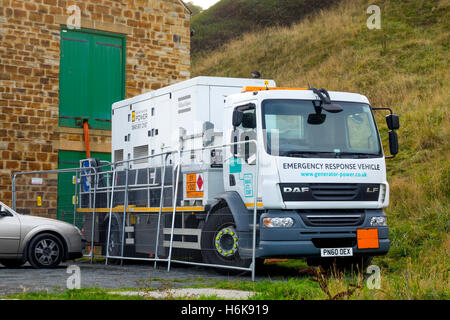 Emergency Vehicle Lorry Mounted electric power generator hooked up to supply power to a small sewage treatment plant. Stock Photo