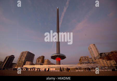 Brighton Sussex UK 30th October 2016 - Visitors enjoy the beautiful sunset at another extra Autumn low tide in Brighton by the BA i360 observation tower at dusk this evening as the unusually mild weather continues in the south of the UK Credit:  Simon Dack/Alamy Live News Stock Photo