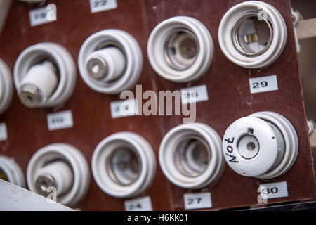 An old fuse panel with ceramic fuses from East Germany seen in the former 'people's swimming pool' in the district of Lankow in Schwerin, Germany, 12 October 2016. The sports pool from the Honecker era is being converted into an extravagant apartment building. Just before demolition, one of the last GDR 'people's swimming pools' was put on the list of landmarks. The Schwerin-based architects' office 'Schelfbauhuette' is saving the East German indoor pool from the 1970s. For 2.5 million euros, eight accessible and eight maisonettes will be put in and the 25m swimming pool will be partially main Stock Photo