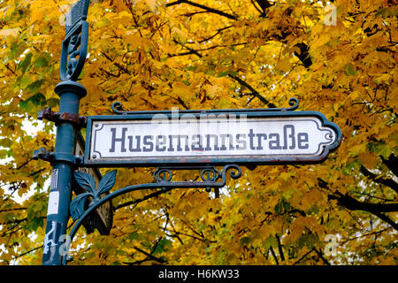 Ornate old street sign at Husemannstrasse in bohemian Prenzlauer Berg during Autumn in Berlin Germany Stock Photo