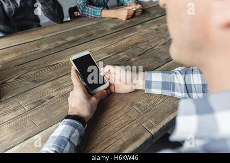 Detail of hipster modern business people using smart phone in loft office Stock Photo