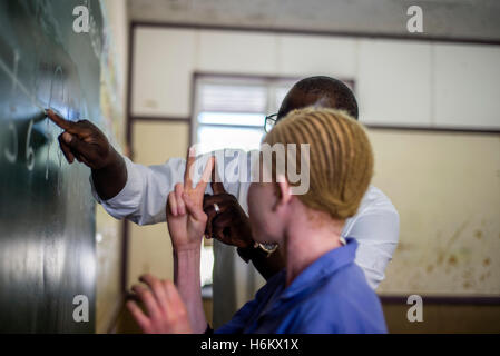 The teacher Richard Tjaronda shows easy way of counting with the number line for his learners during Mathematic lesson at Eluwa Special School in Ongwediva, Namibia. Stock Photo