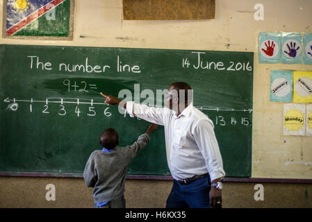 The teacher Richard Tjaronda shows easy way of counting with the number line for his learners during Mathematic lesson at Eluwa Special School in Ongwediva, Namibia. Stock Photo