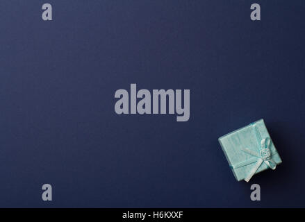 horizontal top view of gift box on minimal dark blue background paper textures Stock Photo