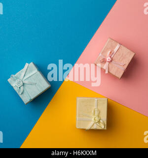 top view of colored gift boxes on minimal background of different kinds of paper textures Stock Photo