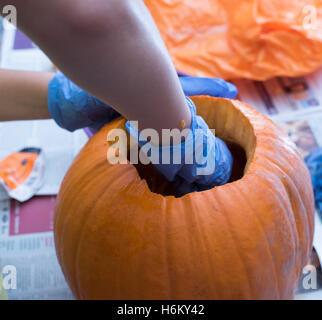 Pumpkin caring, scooping out Stock Photo