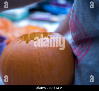 pumpkin carving- scooping out Stock Photo