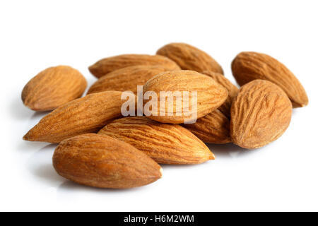 Pile of whole almonds isolated on white. Stock Photo