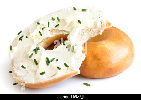 Plain bagel spread with cream cheese and chives, bite missing. Isolated. Stock Photo