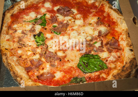 The classic Neapolitan pizza in a take-away box. Stock Photo