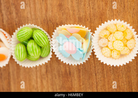 Types of candies placed in small bowls by type and color Stock Photo