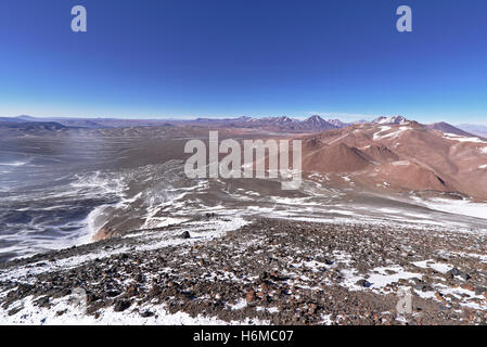Red mountains seen from the top of a volcano in a sunny day and a clear blue sky. Stock Photo