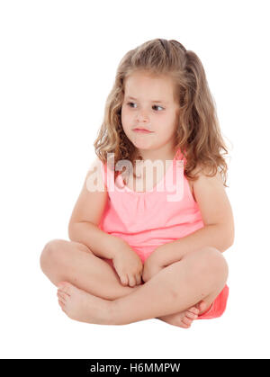 Pensive little girl sitting on the floor isolated on a white background Stock Photo