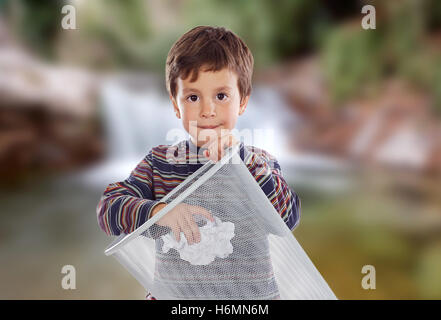 Little kid on the outside throwing a paper in the bin. Stock Photo