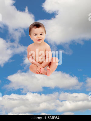 Funny baby in diaper sitting on a cloud on the sky Stock Photo