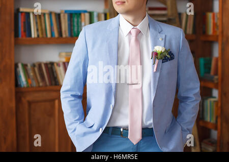 Man in blue suit jacket and pink necktie Stock Photo
