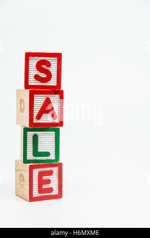 SALE word wooden block arrange in vertical style on white background and selective focus Stock Photo