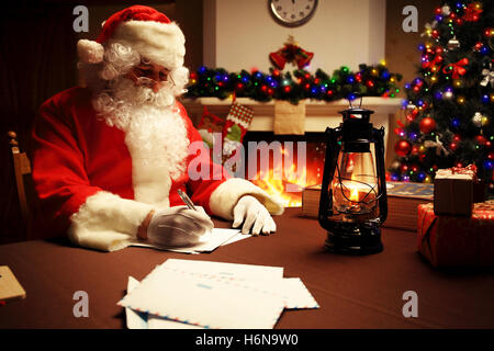 Portrait of Santa Claus answering Christmas letters. Stock Photo