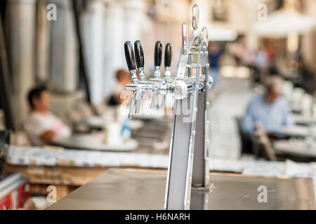 Drought beer taps and other beverages in a bar. Stock Photo