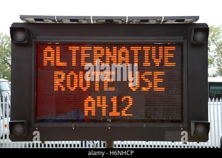 Closeup of a roadside mobile, solar powered dot-matrix road sign showing the message: Alternative Route Use A412 Stock Photo