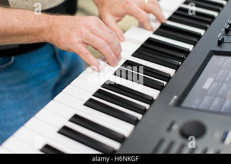 Keyboard player performing on stage live concert Stock Photo