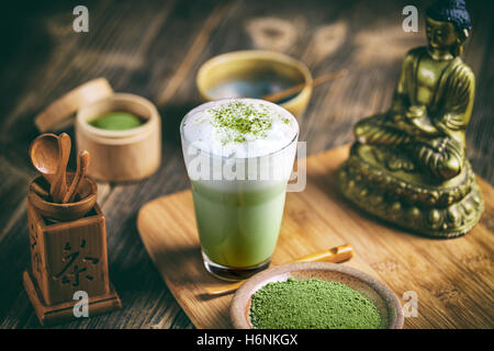 Still life with Japanese matcha accessories and matcha tea latte in glass Stock Photo