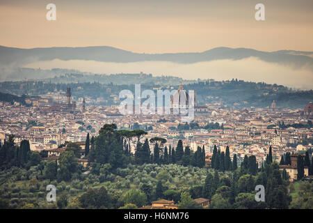 Florence or Firenze aerial foggy morning cityscape. Panorama view from Fiesole hill. Palazzo Vecchio and Duomo Cathedral. Tuscan Stock Photo