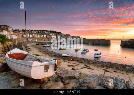 Stunning sunrise over fishing boats at Mousehole near Penzance in Cornwall Stock Photo
