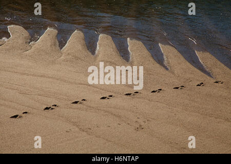 Sand waves on the beach in Lisbon, Portugal Stock Photo