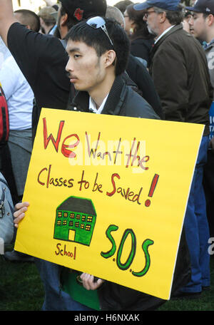 A activist holding a sign reading 'We want the classes to be saved! School S.O.S..' at a protest of big banks, bailout. Stock Photo