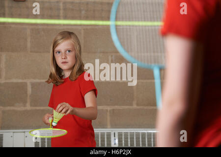 Two Girls Playing Badminton In School Gym Stock Photo