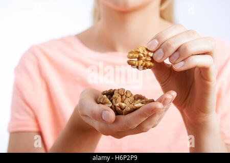 Close Up Of Woman Eating Walnuts Stock Photo