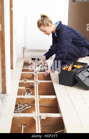 Female Plumber Fitting Central Heating System Stock Photo