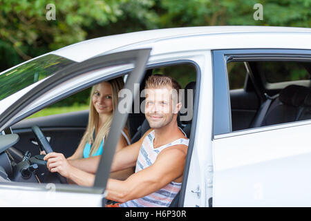Young happy people enjoying a roadtrip in the car Stock Photo