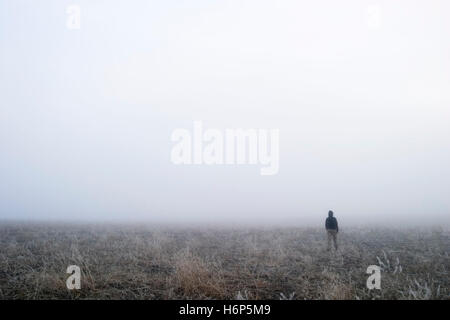 woman walk go going walking female winter male masculine cloud snow coke cocaine material drug anaesthetic addictive drug fog Stock Photo