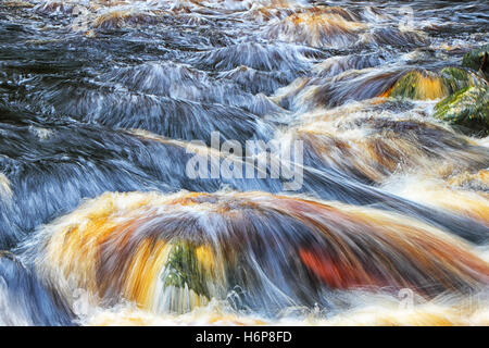 A close up shot of the River Washburn in the Yorshire dales, this image was taken on a slow shutter speed to enhance the flow of Stock Photo