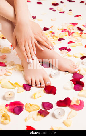 Female gentle hand laying on legs Stock Photo