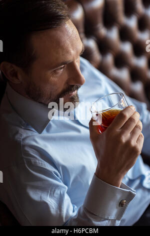 Confident brutal man drinking whisky Stock Photo