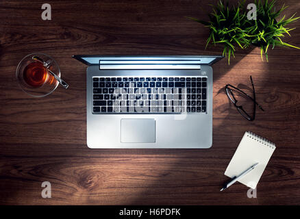 close up view of nice silver laptop on wooden desk top Stock Photo