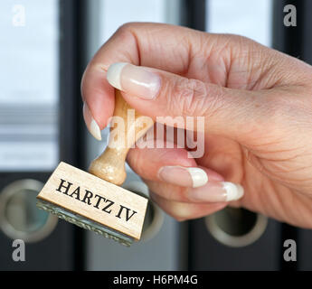 hartz iv - stamp labour office with hand Stock Photo