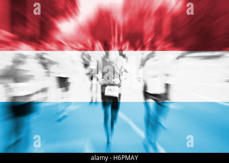 Marathon runner motion blur with blending  Luxembourg flag Stock Photo