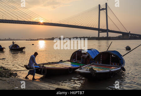 Wooden country boats used for pleasure boat rides lined up at Princep Ghat on river Hooghly at sunset. Stock Photo