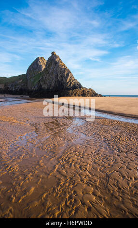 Pennard Pill flows past the three cliffs at Three Cliffs Bay, Gower, South Wales, UK. Stock Photo