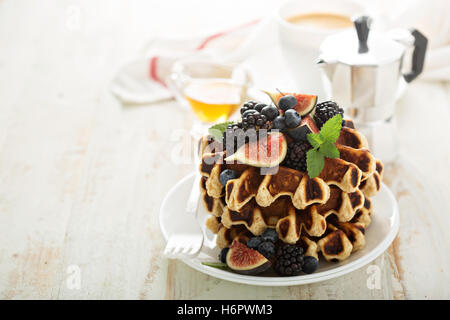 Fluffy breakfast waffles with fresh fruits Stock Photo
